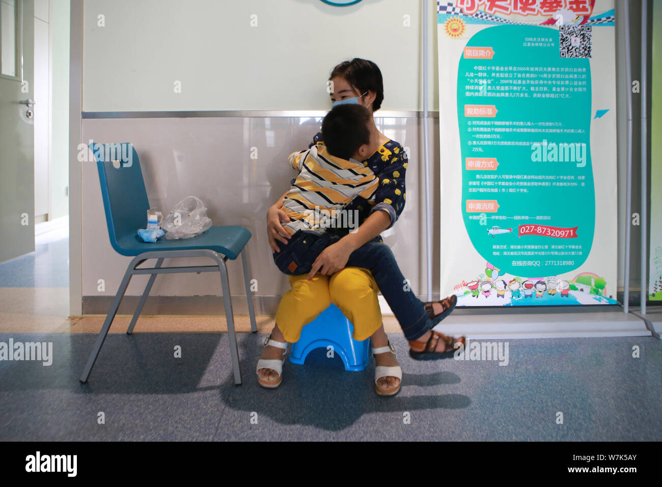 The mother hugs 6yearold Chinese boy Xiao Zhi donating bone marrow to save his elder brother