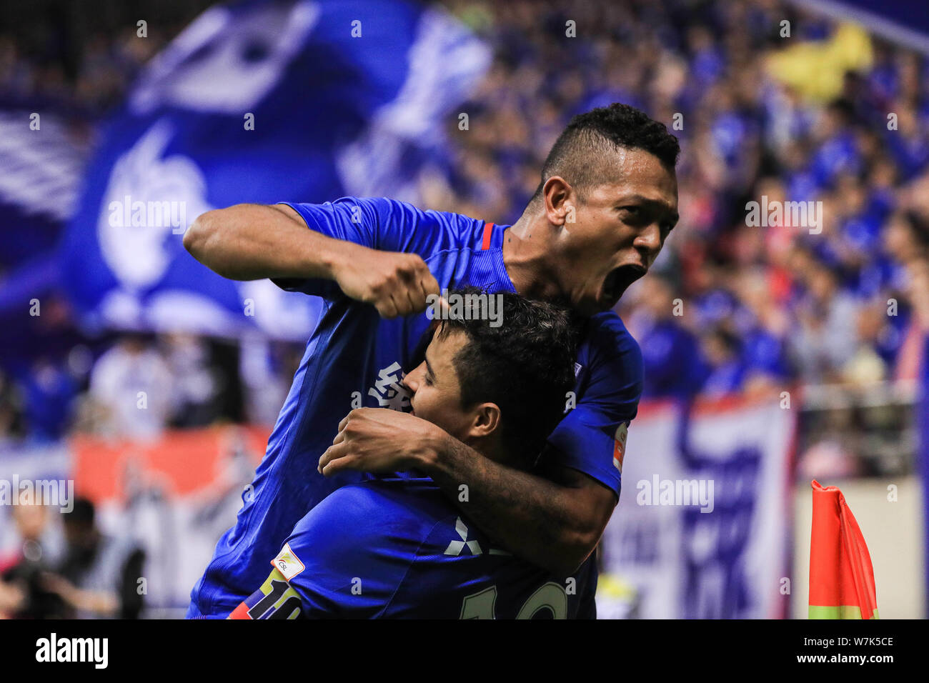 Colombian football player Fredy Guarin, upper, of Shanghai Greenland Shenhua, celebrates with his teammate Colombian football player Giovanni Moreno a Stock Photo