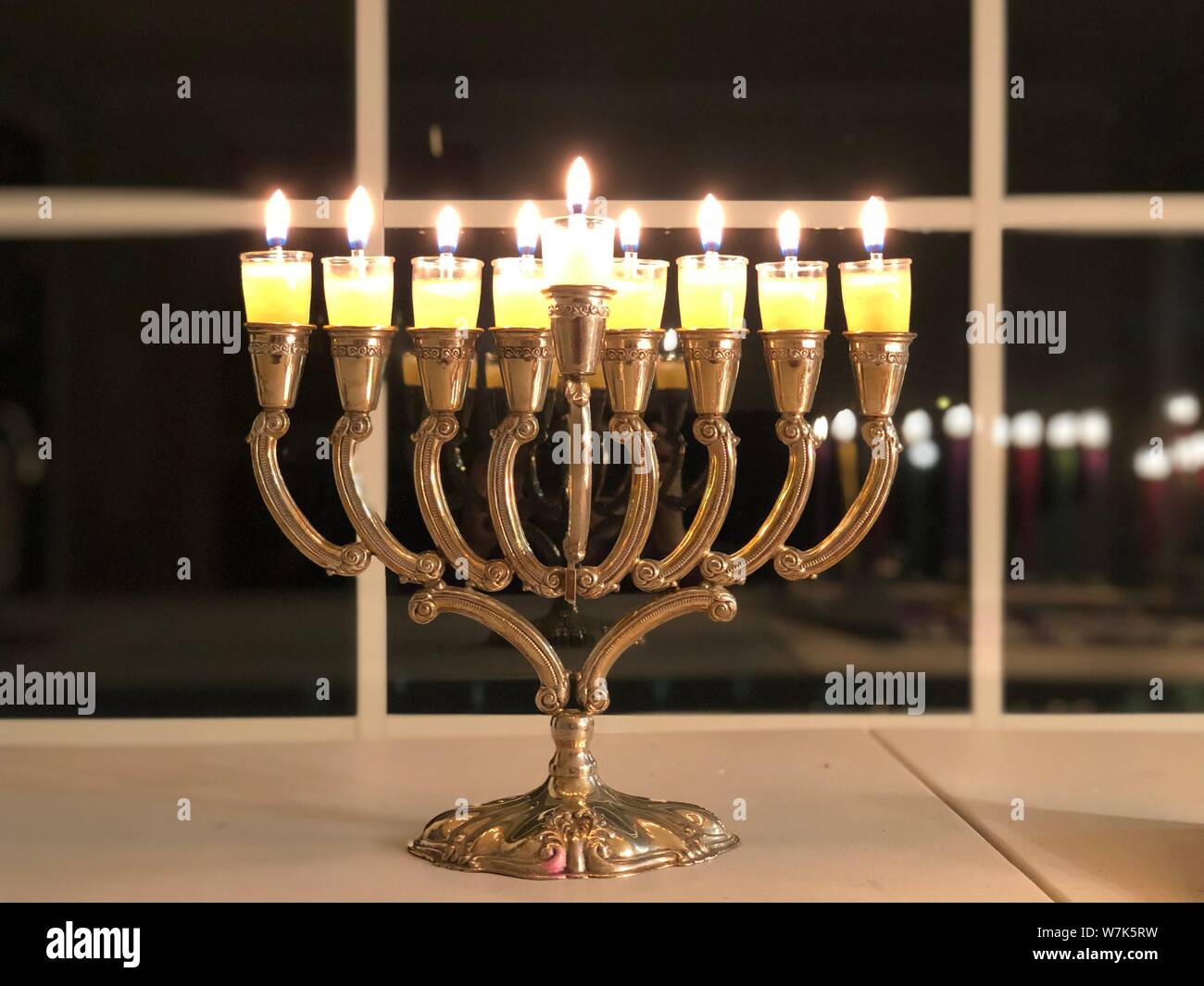 Hanukkah Menorah Candle Lighting Jewish holidays symbol traditional religious lights in the dark Stock Photo