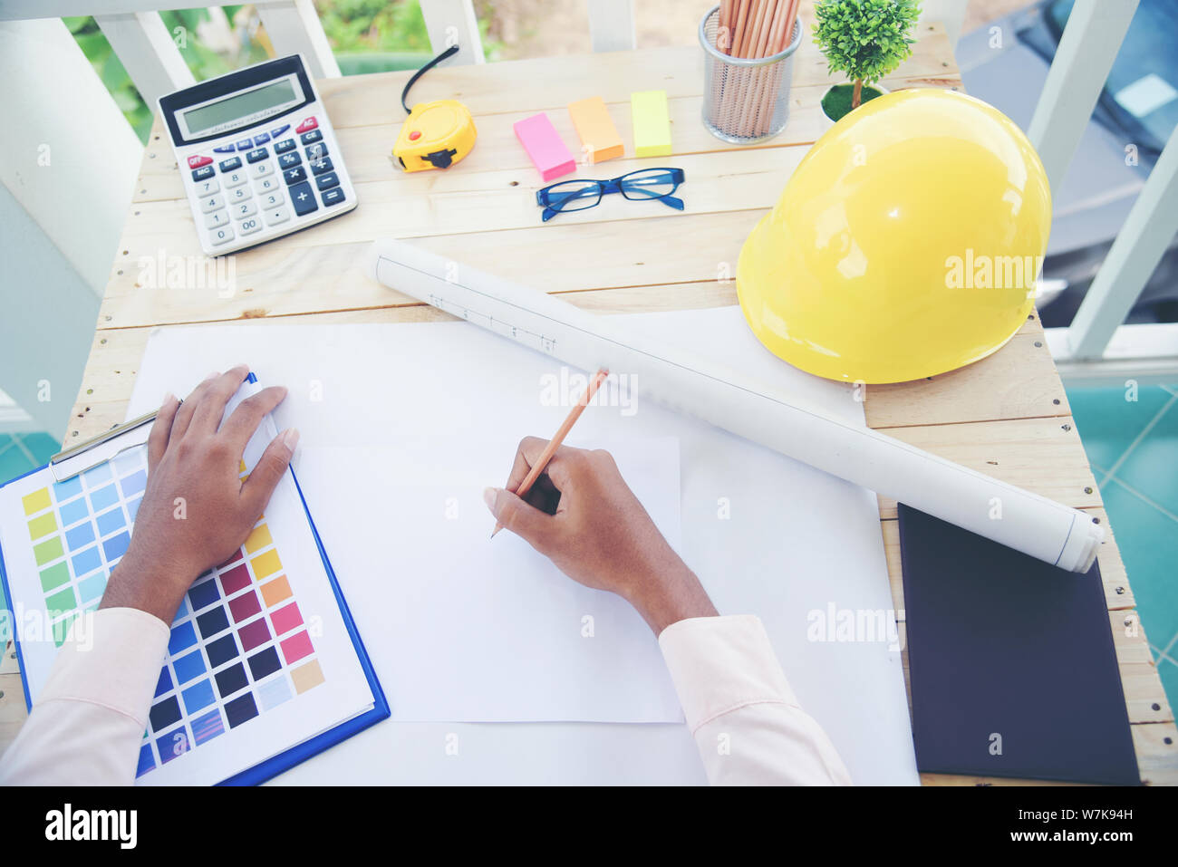 Young architect designer working with new project. Architecture Construction Concept. Stock Photo