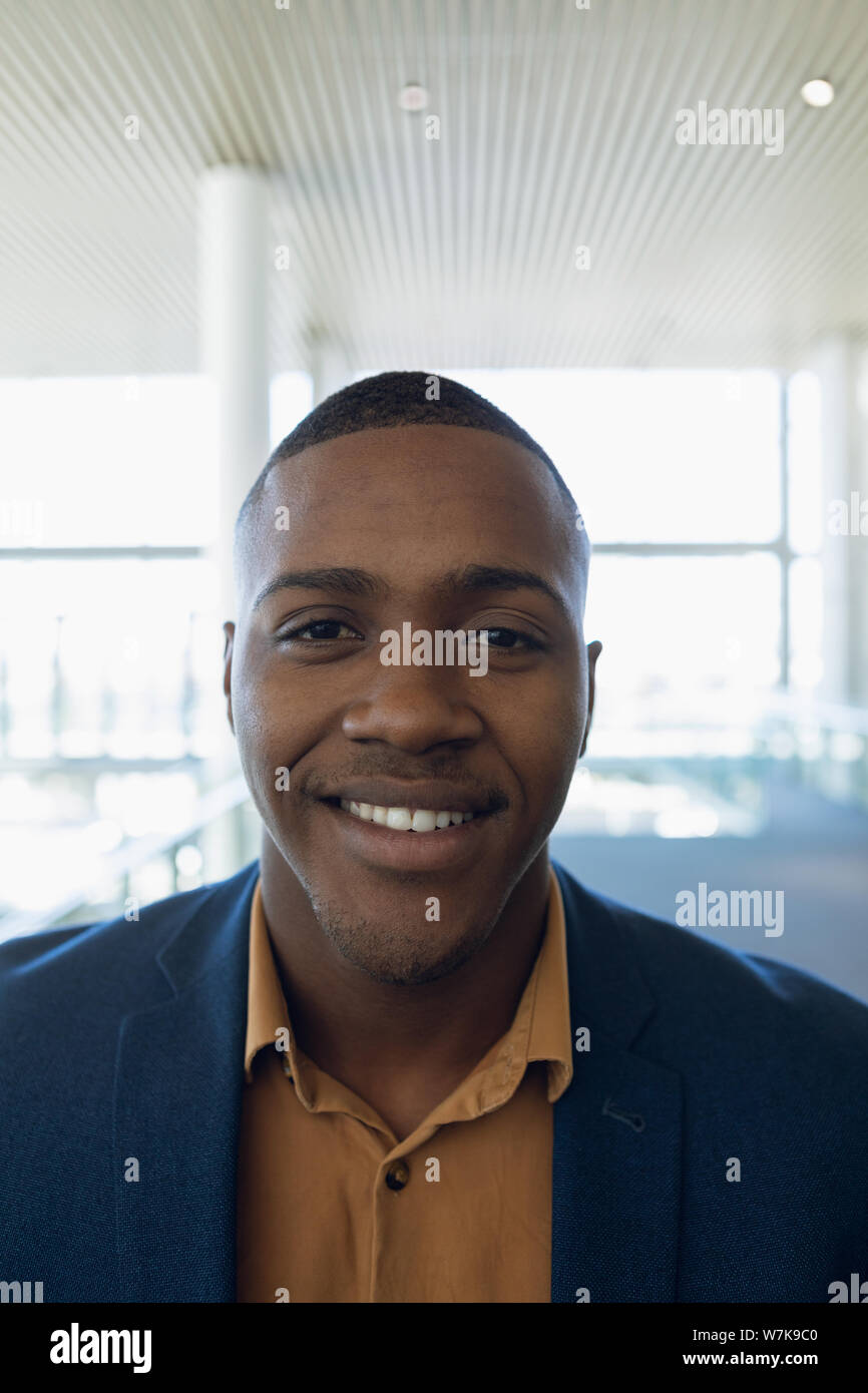 Businessman smiling to camera at work Stock Photo