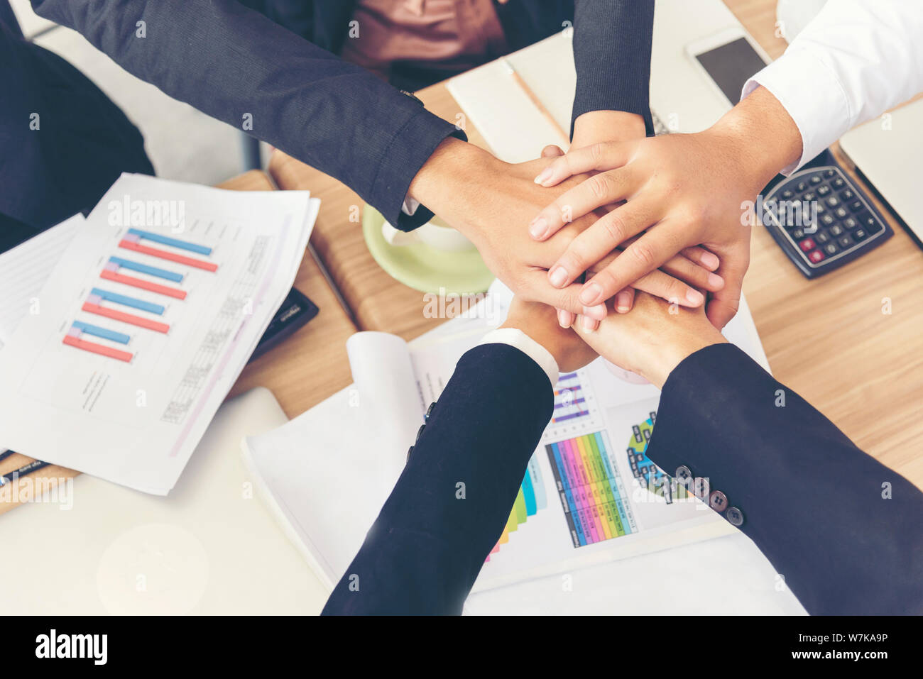 Teamwork Concept. Group of young businessman teamwork touching shaking hands together. Stock Photo