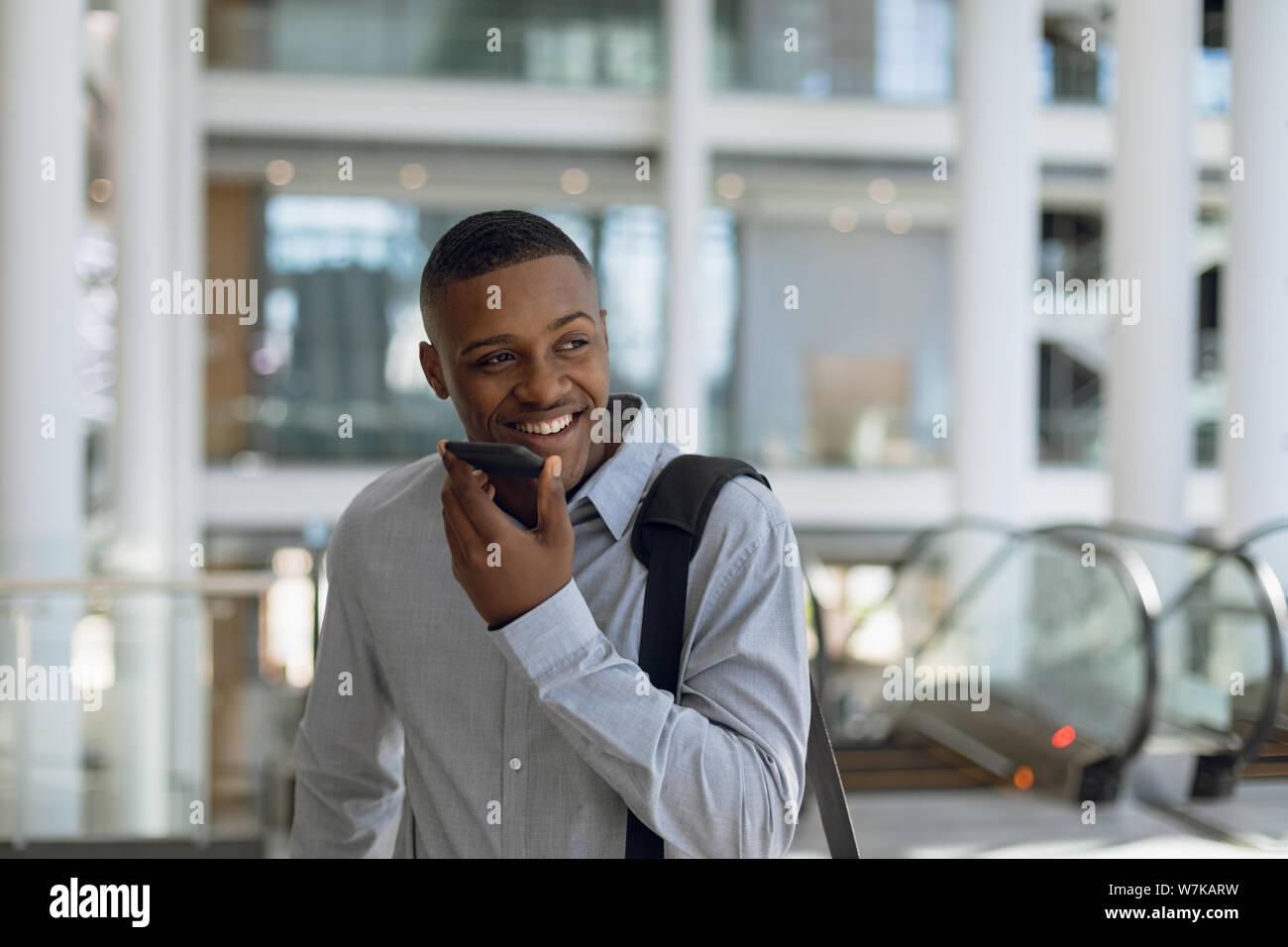 Businessman using smartphone in modern building Stock Photo