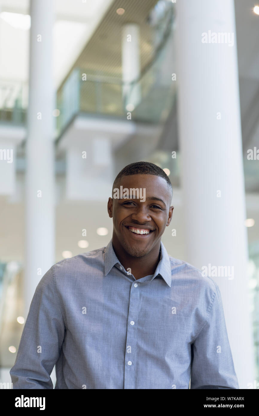 Smiling businessman in modern business building Stock Photo