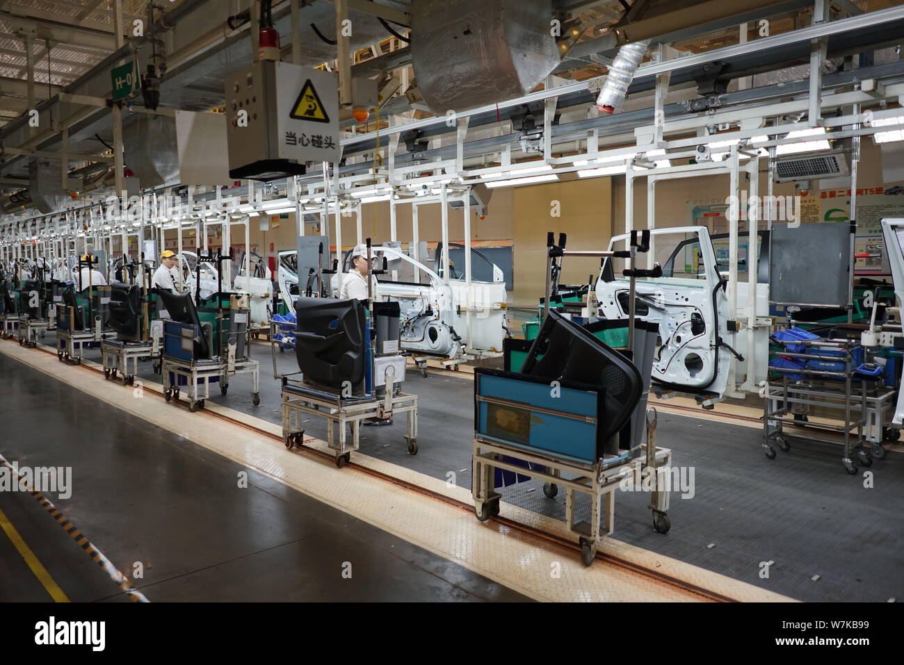 --FILE--Chinese workers assemble cars on the assembly line at an auto ...