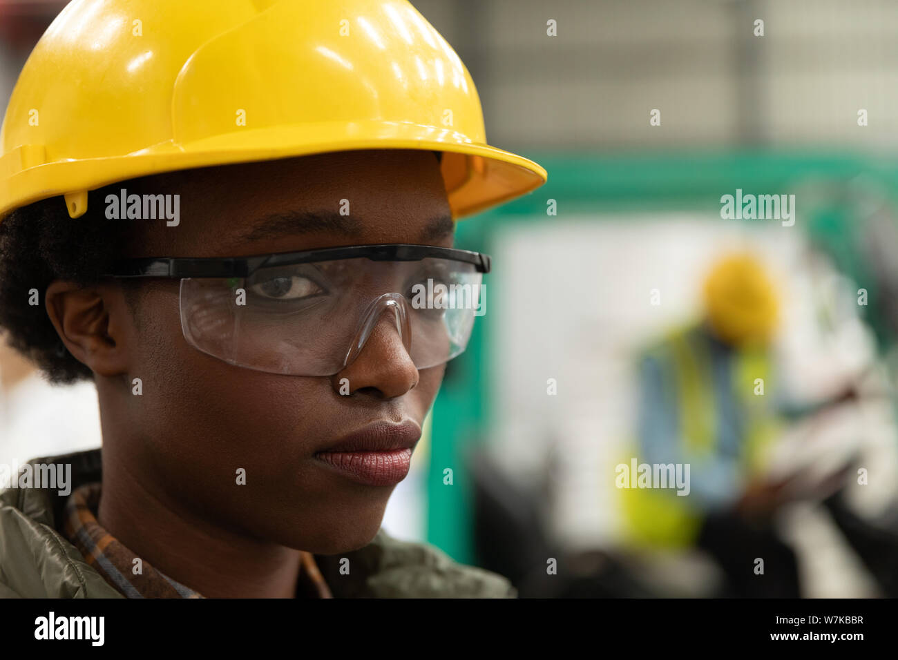 Female worker looking at camera in warehouse Stock Photo