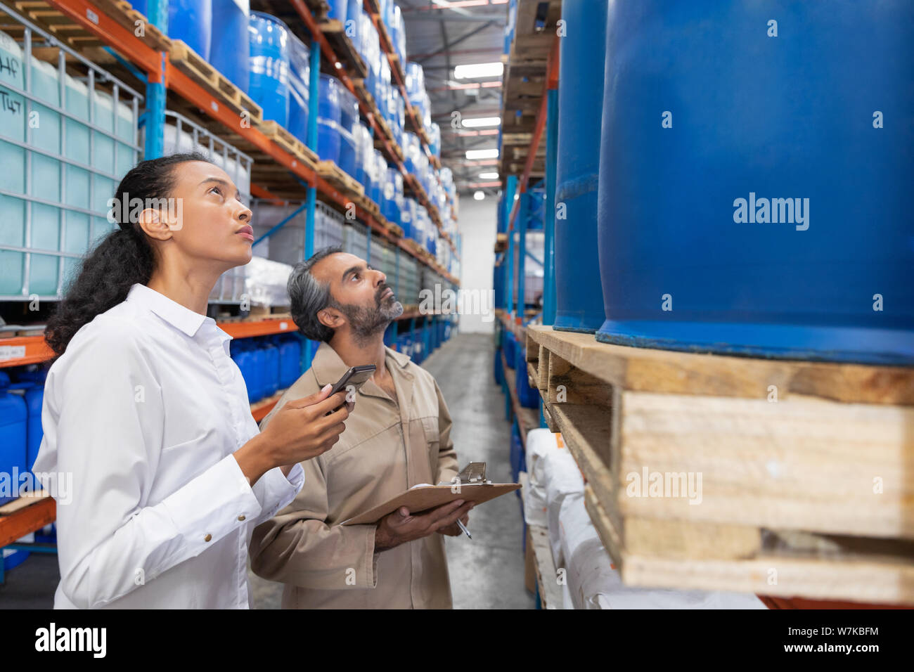 Female manager checking inventory in warehouse Stock Photo