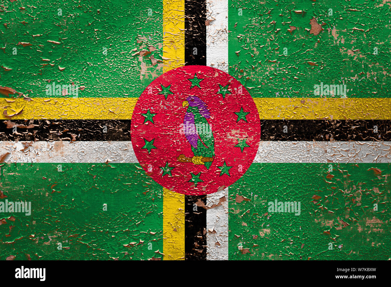 National flag of Dominica on old peeling wall background.The concept of ...