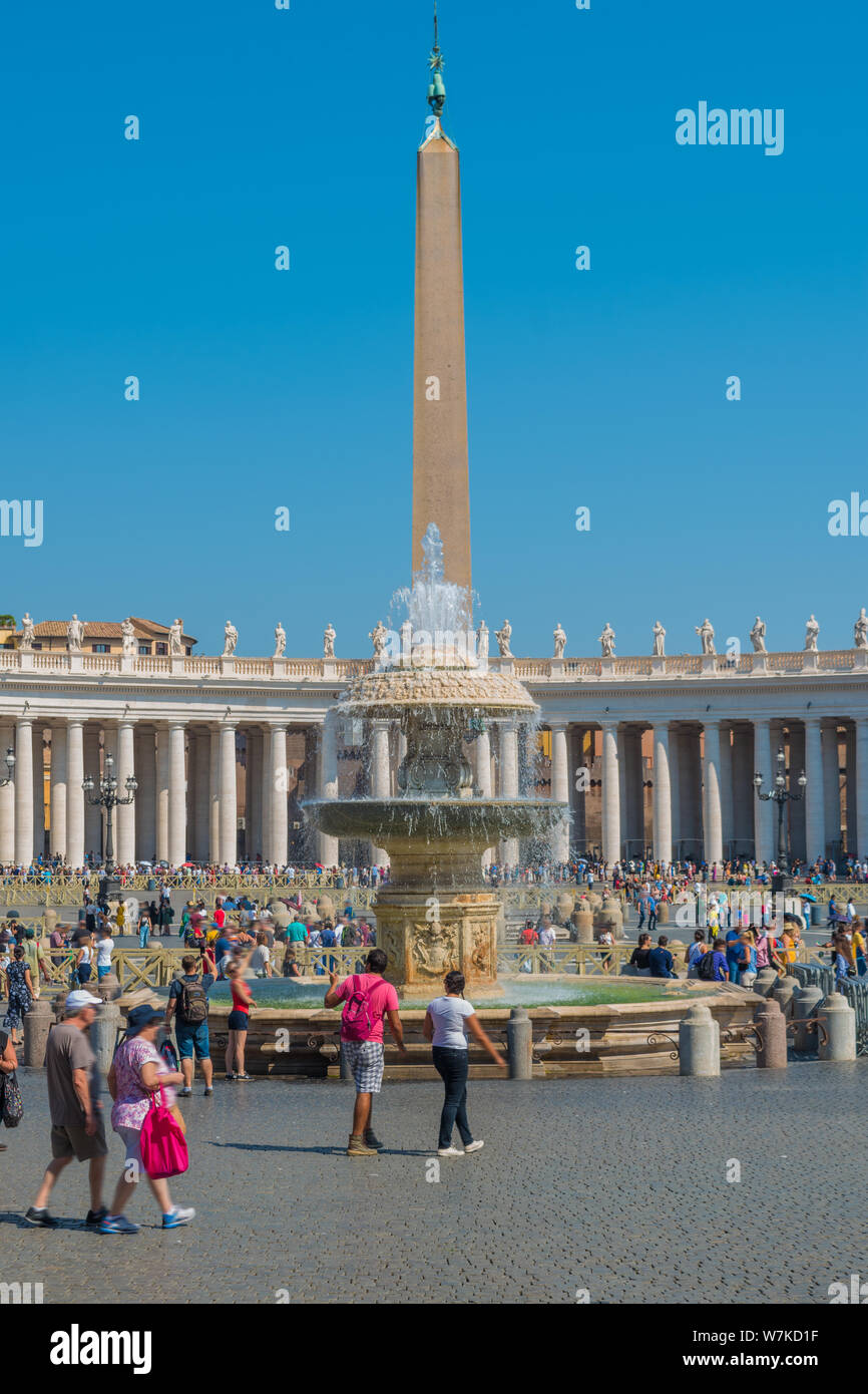 The Bernini Fountain and the Egyptian Obelisk in the center and the Doric colonnades surrounding St. Peter's Square in the Vatican Stock Photo