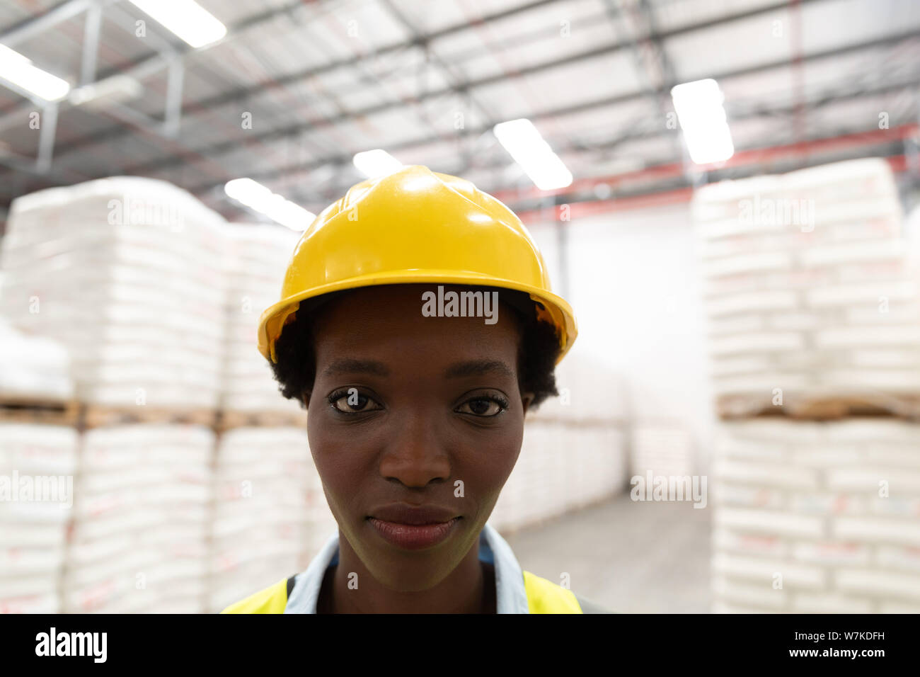 Female worker looking at camera in warehouse Stock Photo