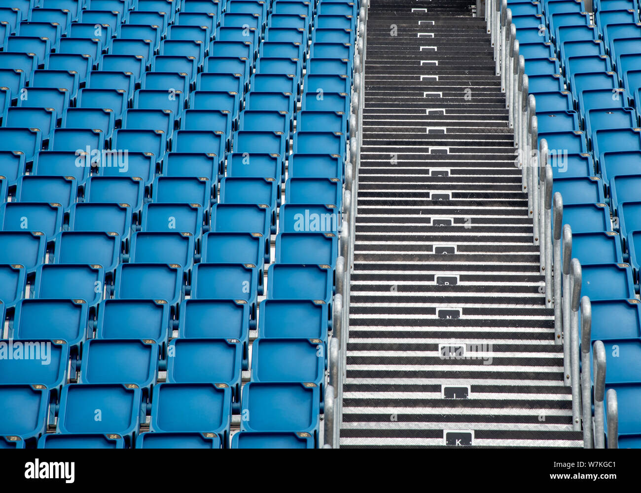 Blue plastic empty stadium or stage chairs in a row Stock Photo