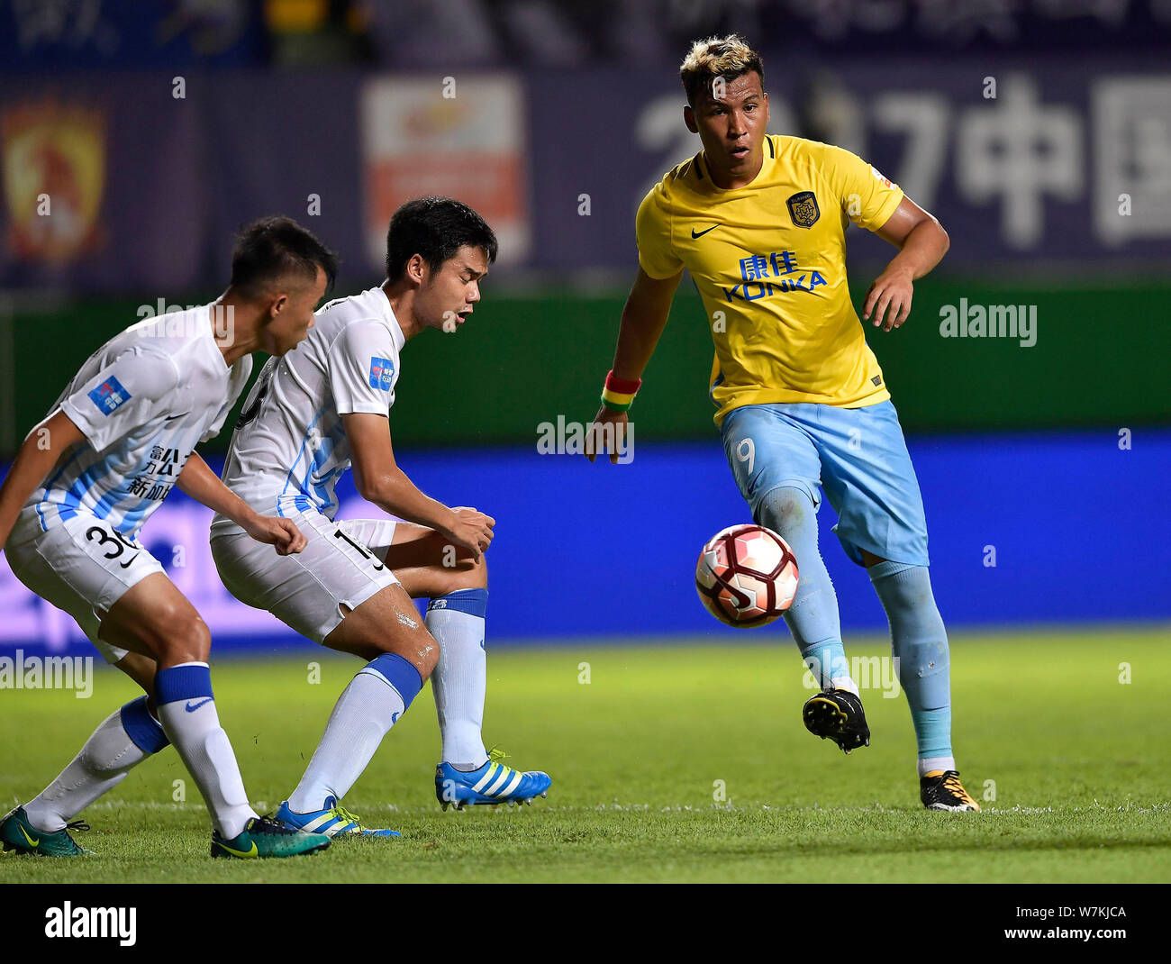 Colombian Football Player Roger Martinez Right Of Jiangsu Suning Kicks The Ball To Make A Pass Against Players Of Guangzhou R F In Their 21st Round Stock Photo Alamy