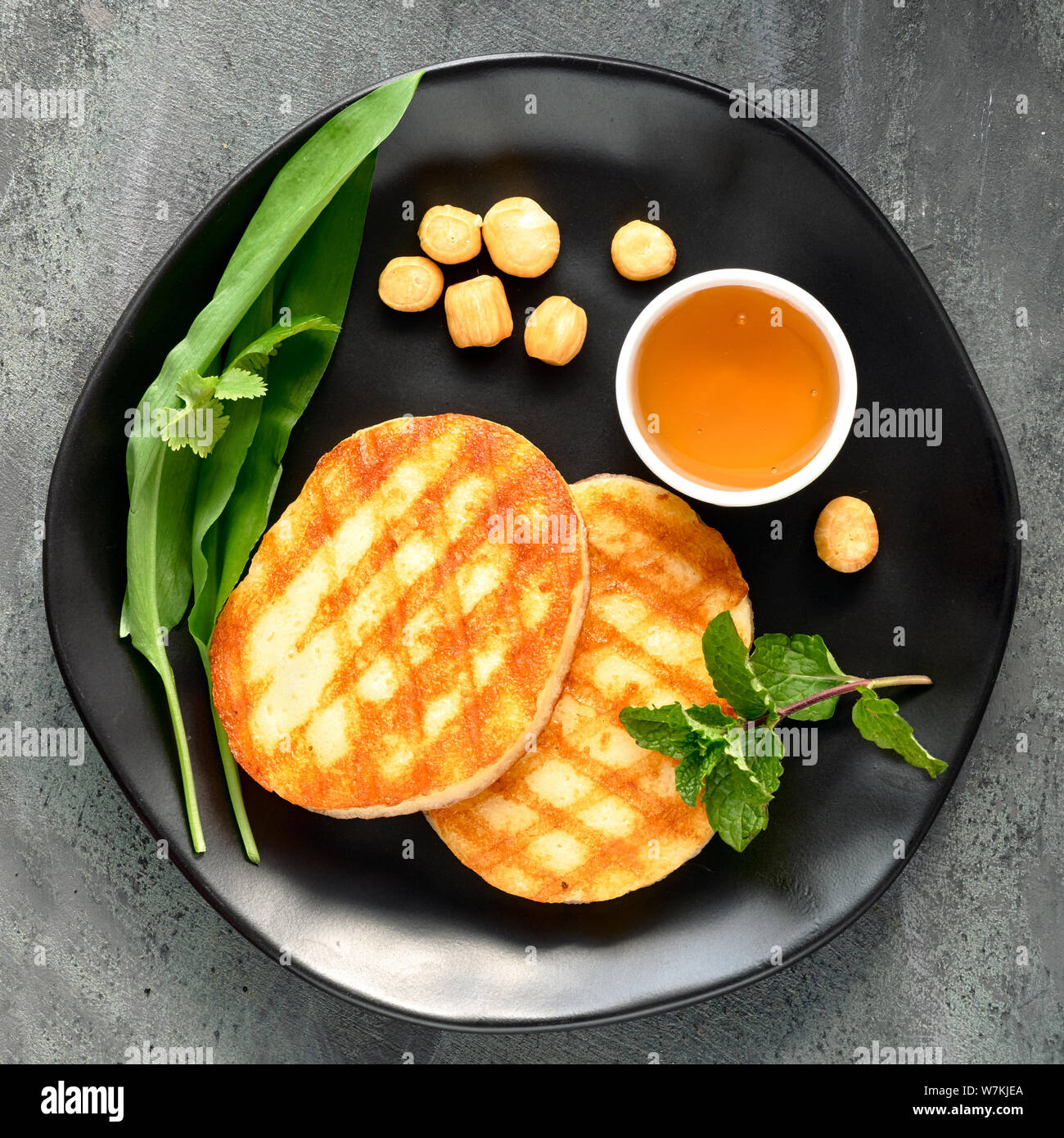 Grilled round slices of Greek cheese with honey, smoke-dried cheese ...