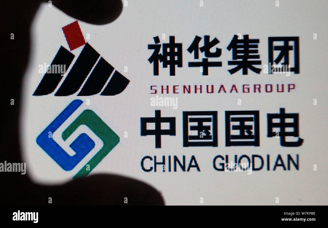 --FILE--A Chinese netizen looks at logos of China Shenhua and China ...