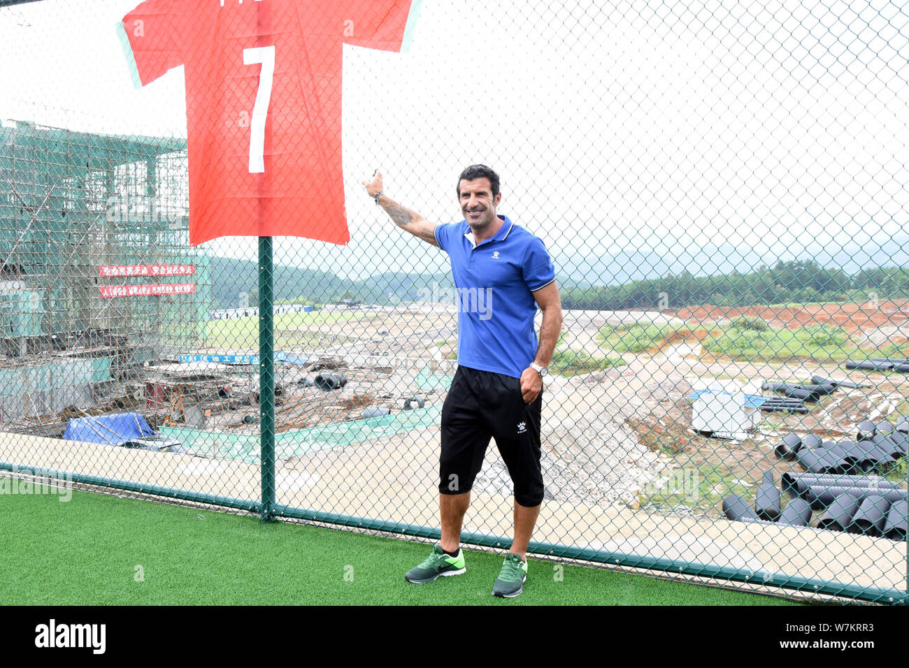 Portuguese football legend Luis Figo takes photos with his jersey during the 2nd Legnd Star China Tour at International Football Town in Duyun city, s Stock Photo