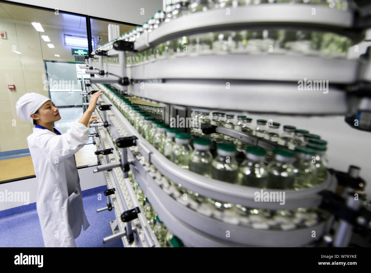 --FILE--A Chinese worker checks infusion bottles on the assembly line ...
