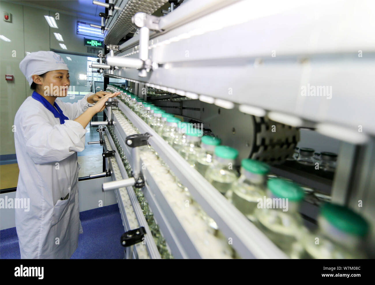 --FILE--A Chinese worker checks infusion bottles on the assembly line ...