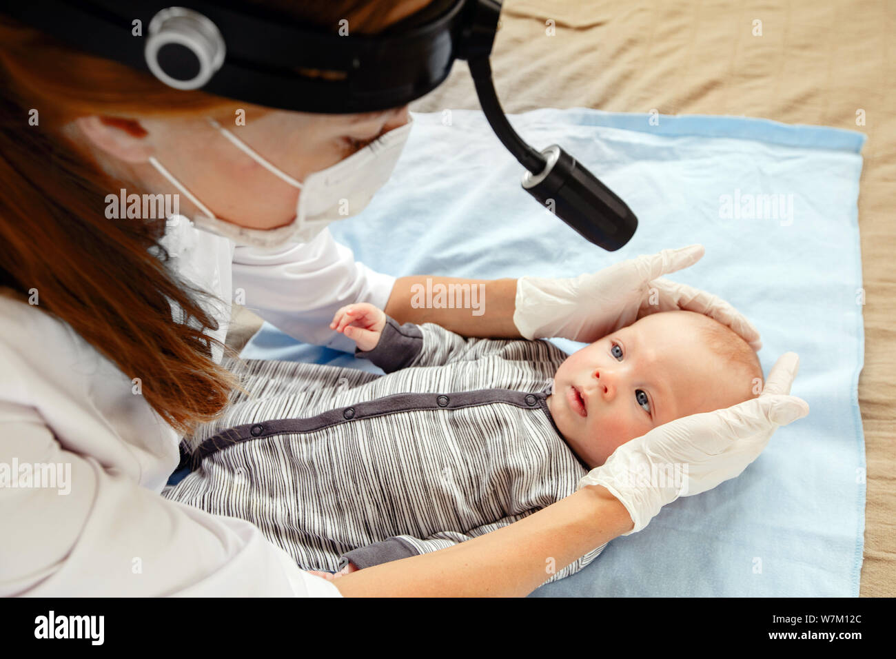 Female nurse examining cute little kid Stock Photo