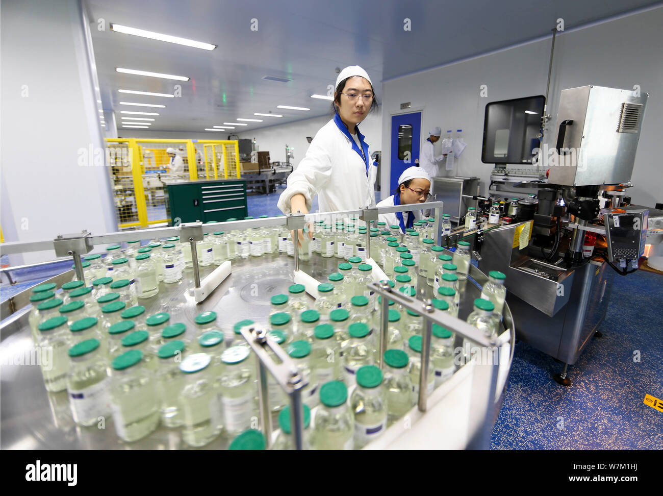 --FILE--Chinese workers check infusion bottles on the assembly line at ...