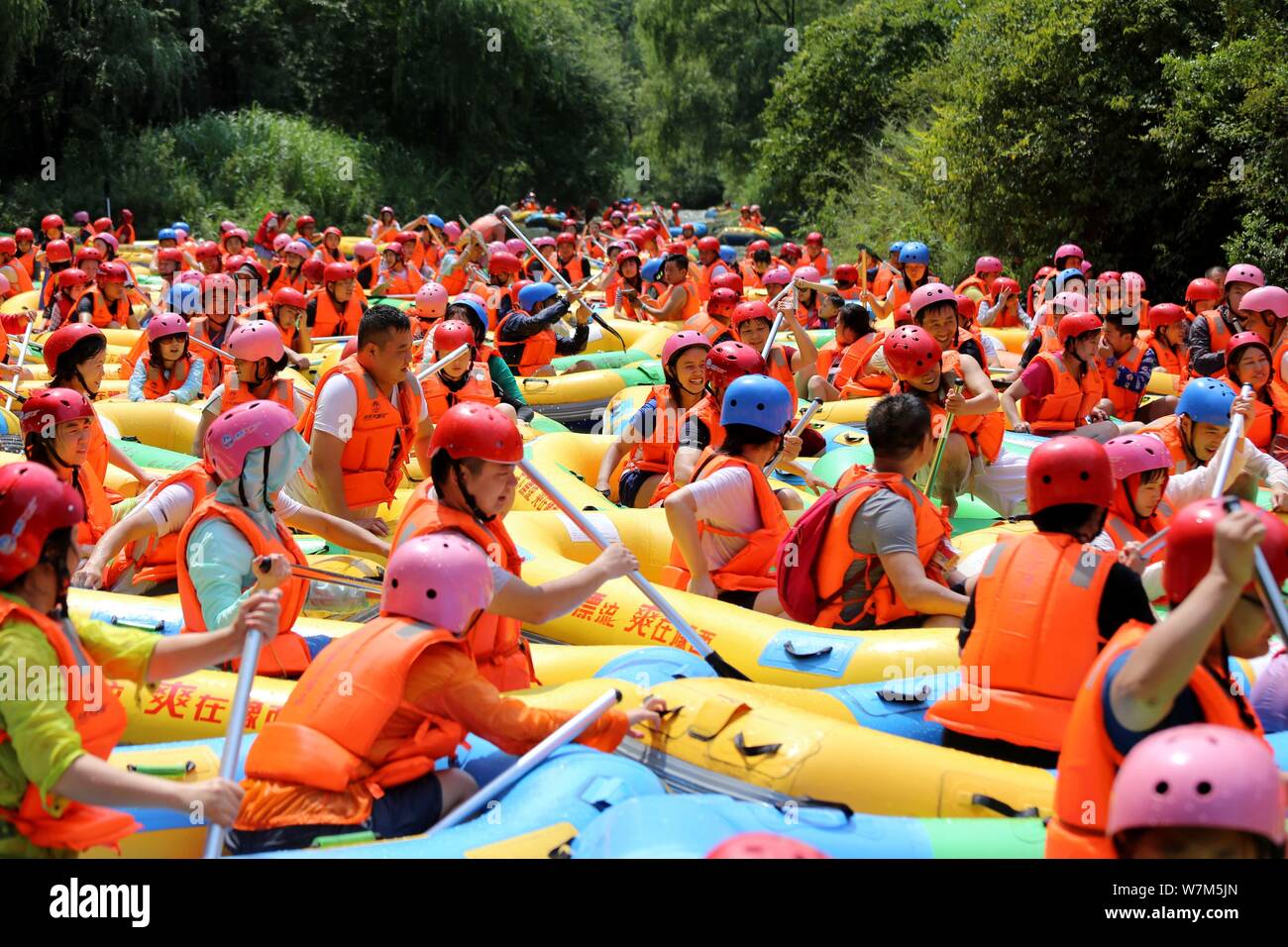 Tourists in life vests enjoy leisure time on rubber rafts at Grand ...
