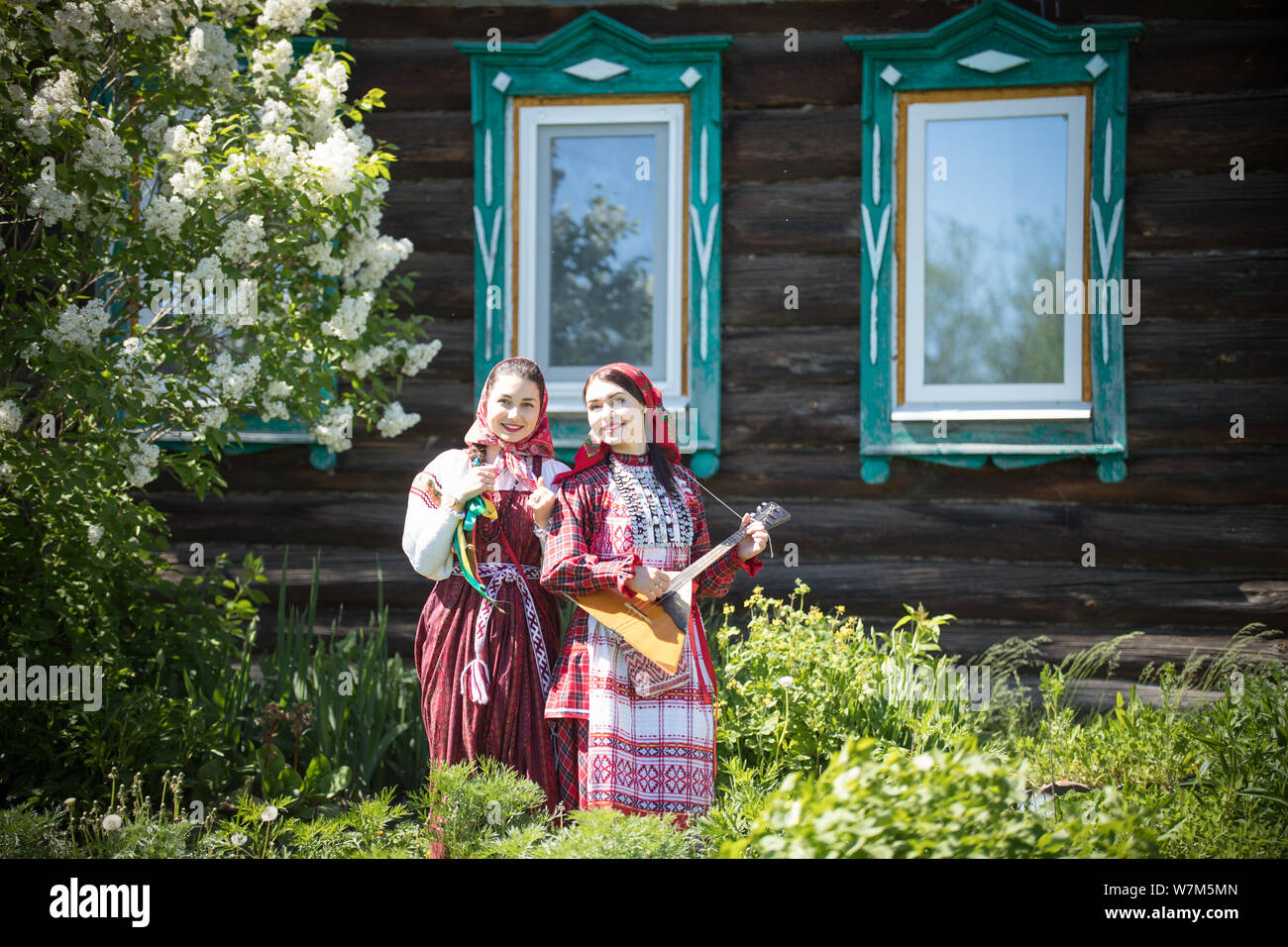 Two young women in traditional russian clothes stand in front of a ...