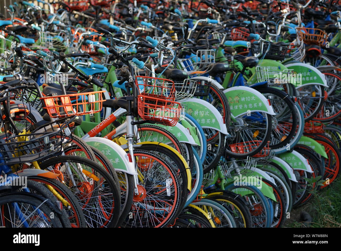 Bicycles of Chinese bikesharing services are piled up under a flyover