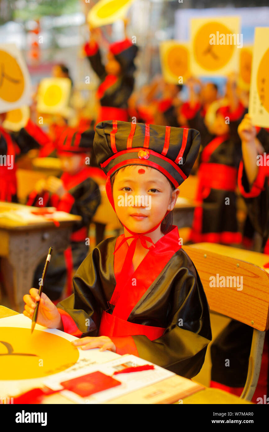 A new firstgrader learns to write the Chinese character "Ren," meaning