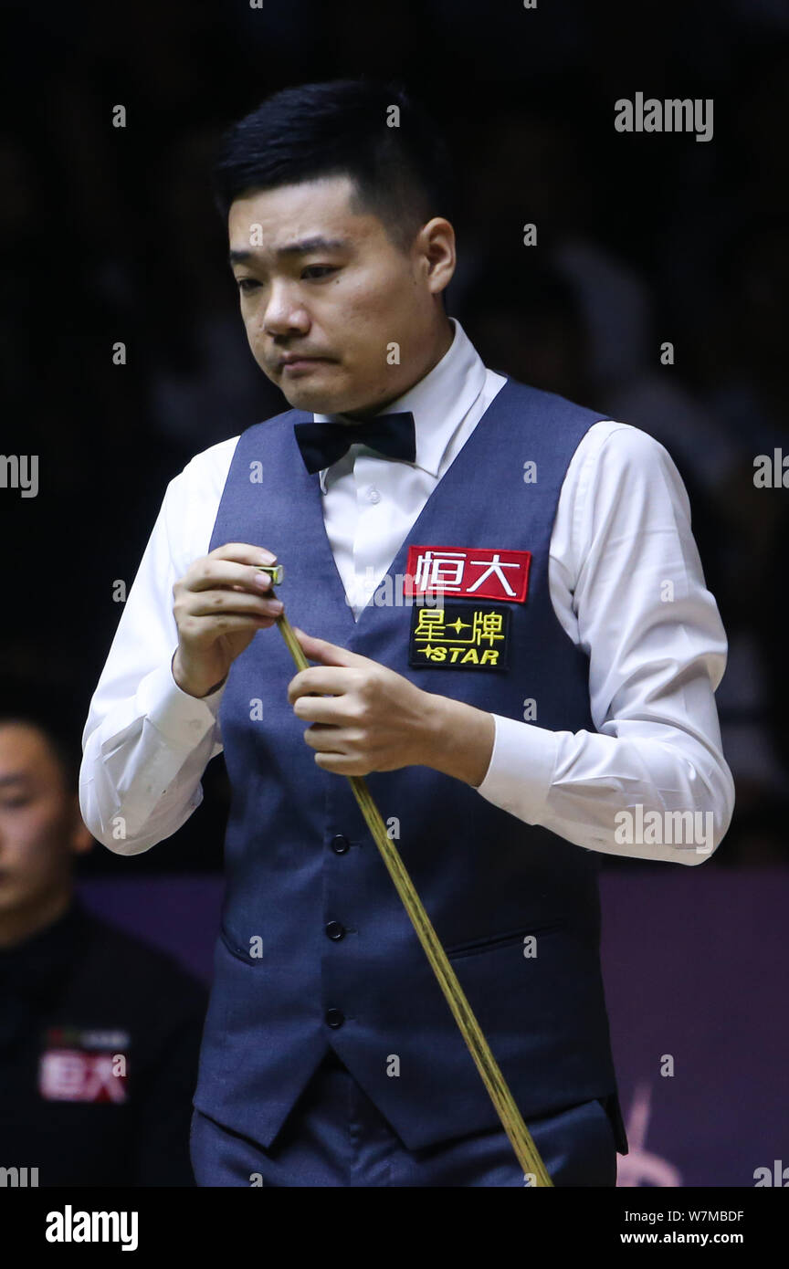 Ding Junhui of China chalks his cue as he considers a shot to Niu Zhuang of China in the qualification match during the 2017 China Championship snooke Stock Photo