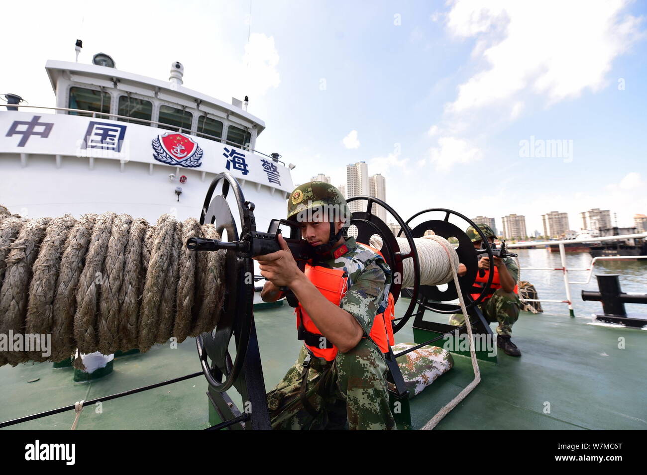 Police officers from China Coast Guard (CCG) take part in an anti-terrorist drill to celebrate the upcoming Army Day (August 1) in Haikou city, south Stock Photo