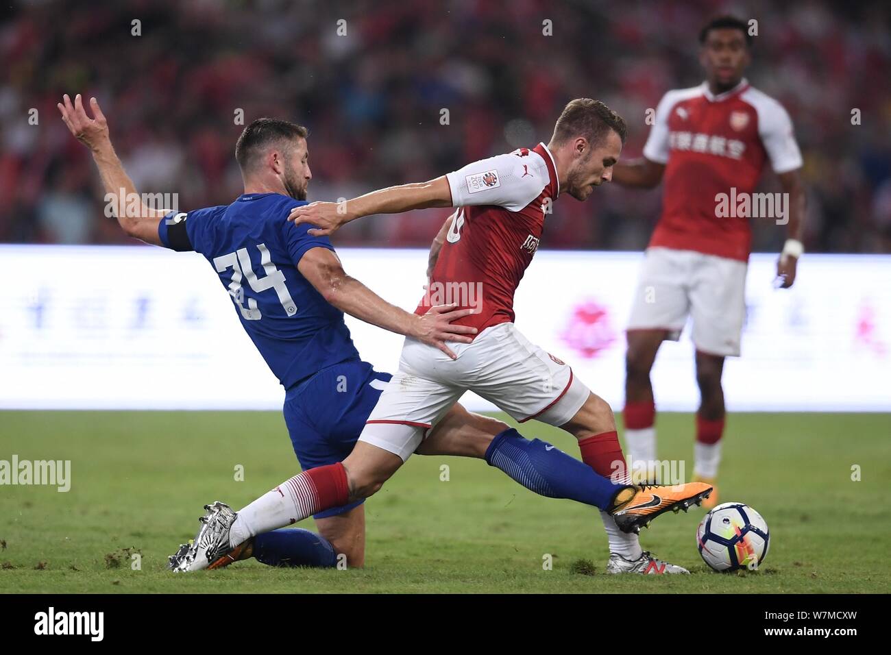 Gary Cahill of Chelsea F.C., left, challenges a player of Arsenal F.C. during the 2017 Beijing Bird's Nest London Derby at the Beijing National Stadiu Stock Photo