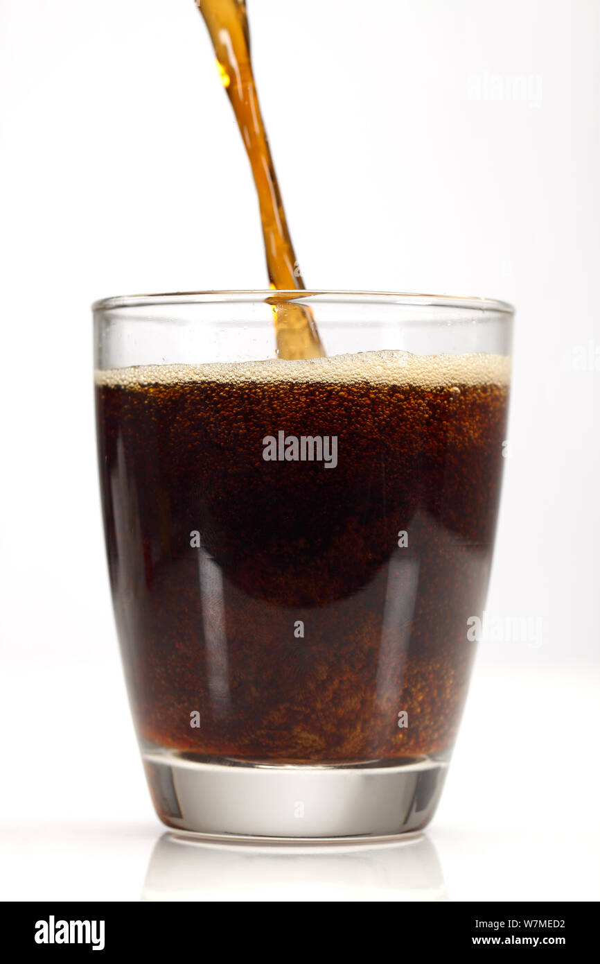 Soft drink being poured into a glass Stock Photo - Alamy