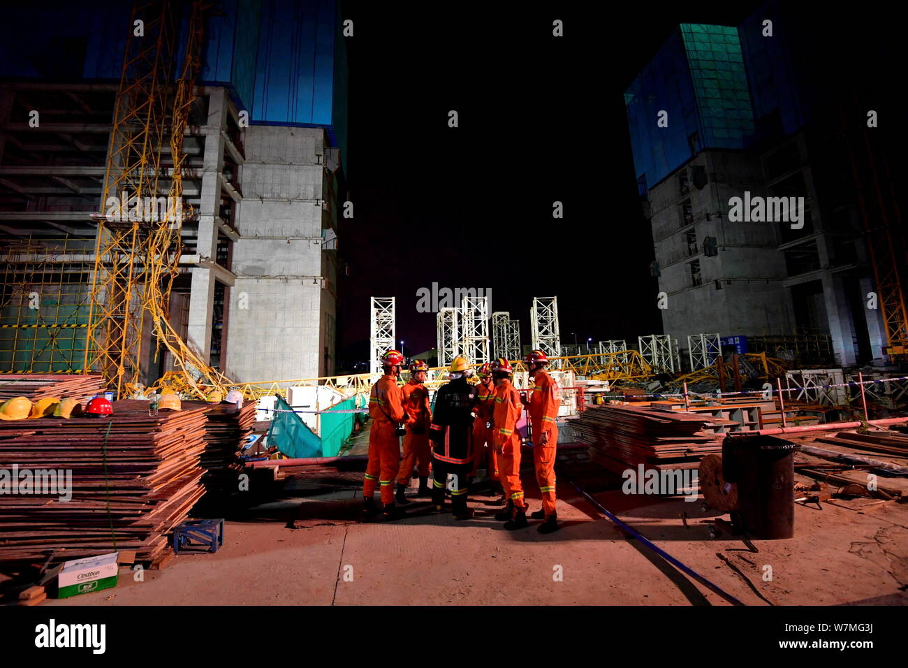 Chinese rescuers try to rescue workers being stuck by he deformed steel ...