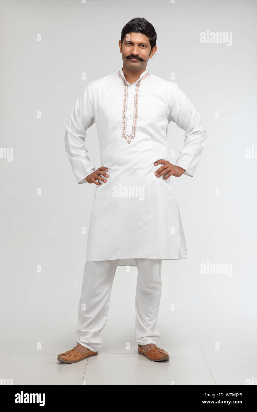 Portrait of a rural man standing with his arms akimbo Stock Photo - Alamy