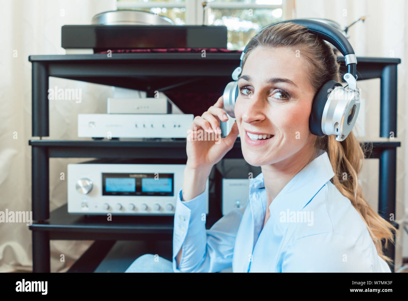 Audiophile woman enjoying music in her home Stock Photo Alamy