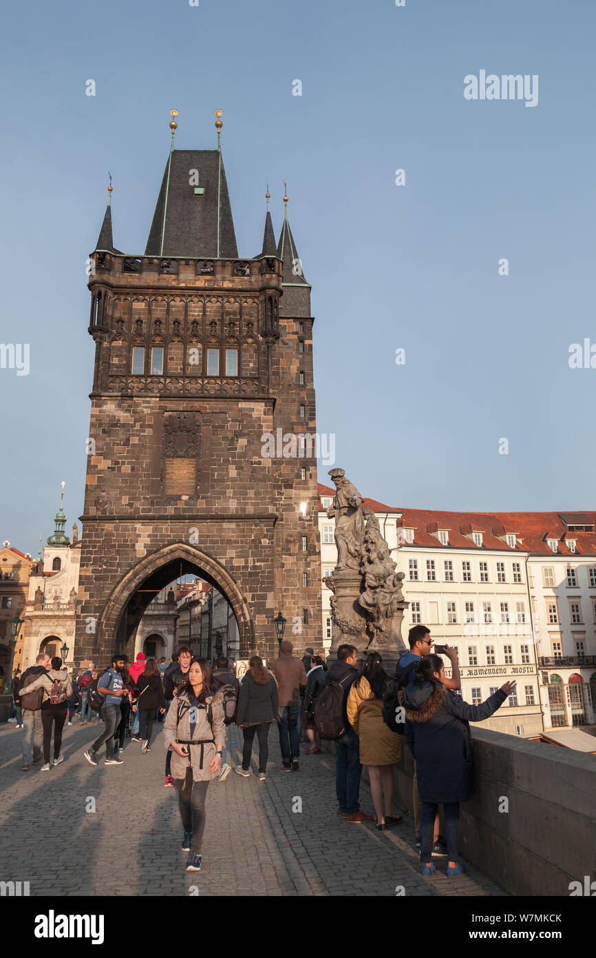 Prague, Czech Republic - May 1, 2017: Tourists walk on Charles Bridge over Vltava river in Prague Old town Stock Photo