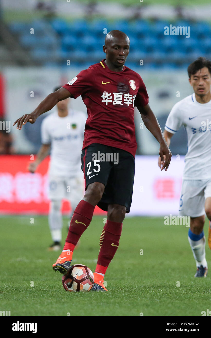 Cameroonian football Stephane Mbia of Hebei China Fortune kicks the ball to make a pass against Guizhou Hengfeng Zhicheng in their 18th round match du Stock Photo
