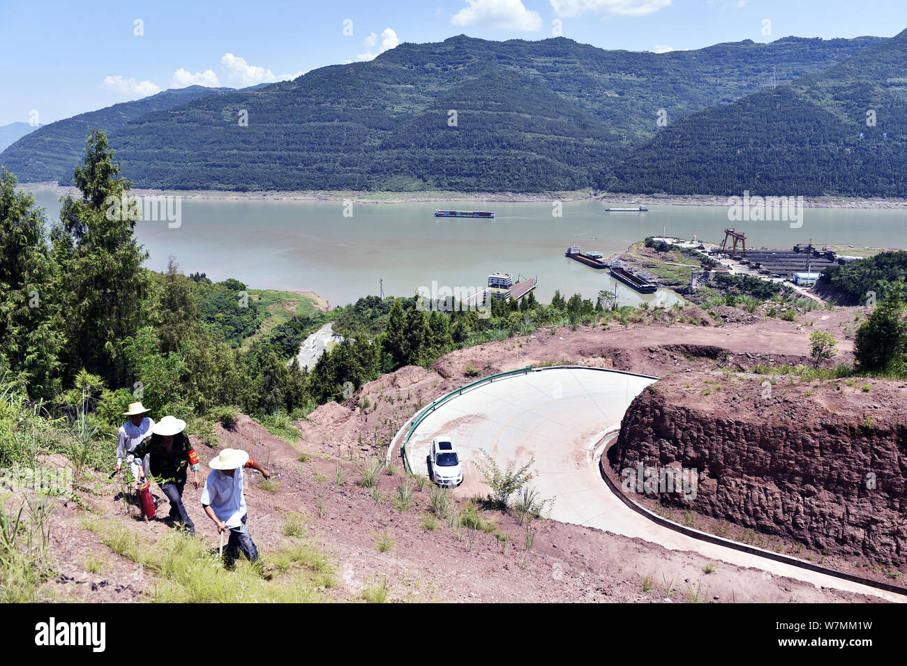 Forestry workers are patrolling along the Yangtze River despite scorching heat at Yunyang county in Chongqing, China, 24 July 2017.   Yunyang Forestry Stock Photo