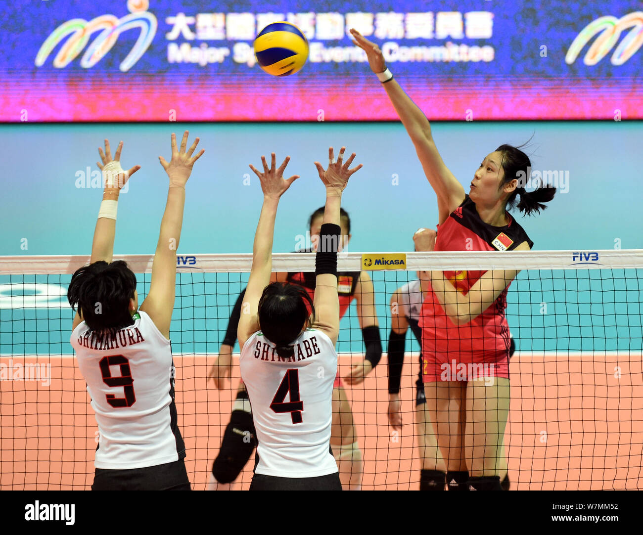 Zhu Ting, right, of China spikes against Haruyo Shimamura, and Risa Shinnabe of Japan during the Pool G1-Group 1 match of the FIVB Volleyball World Gr Stock Photo