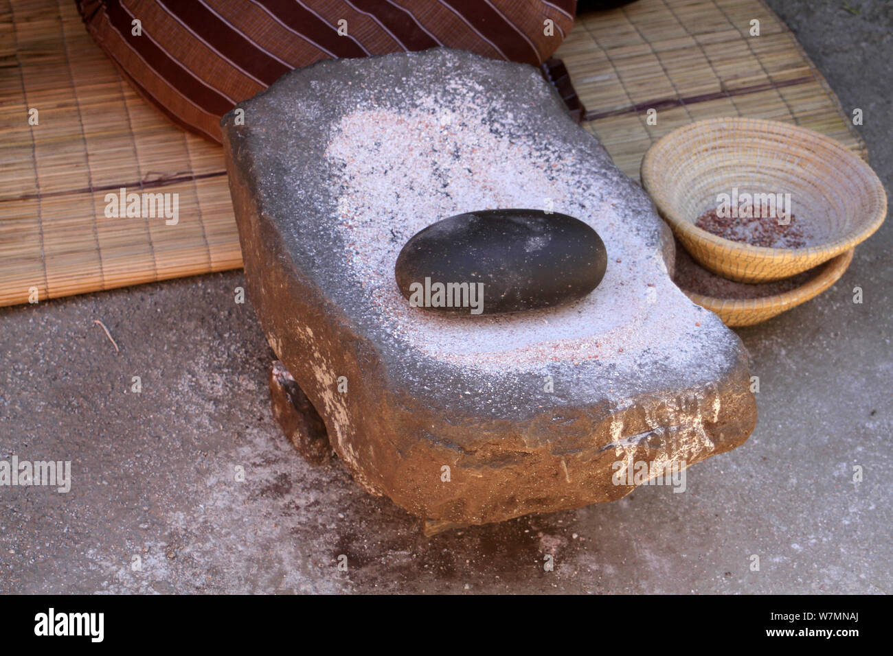 Smooth flat stone and round black stone used to grind maize at Lesedi Cultural Village, Cradle of Humankind, South Africa Stock Photo