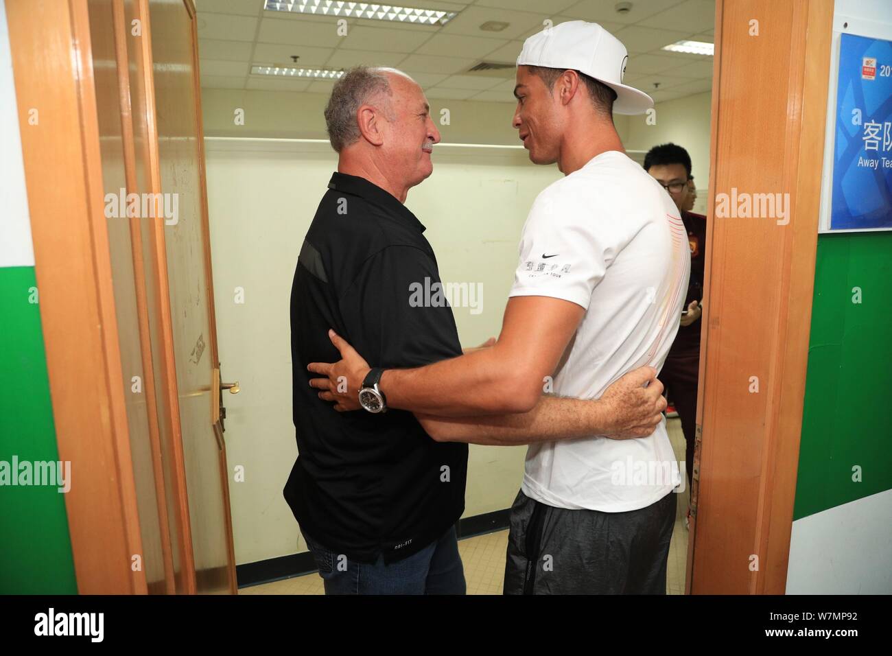 Portuguese football player Cristiano Ronaldo of Real Madrid, right, interacts with head coach Luiz Felipe Scolari of Guangzhou Evergrande F.C. at the Stock Photo