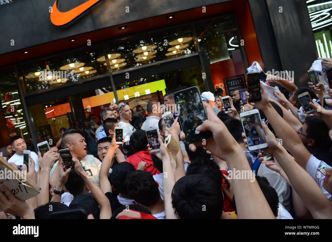 Portuguese football player Cristiano Ronaldo of Real Madrid is surrounded  by fans during a fan meeting event at a Nike sportswear store in Shanghai,  C Stock Photo - Alamy