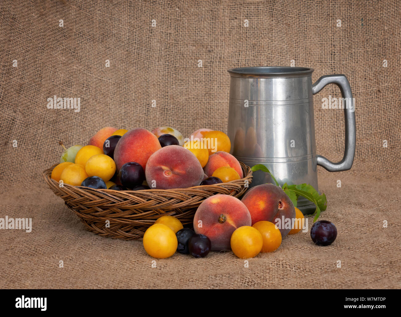 Fruit and ale. Old fashioned fruit from a long abandoned orchard with pewter tankard. Still life. Stock Photo