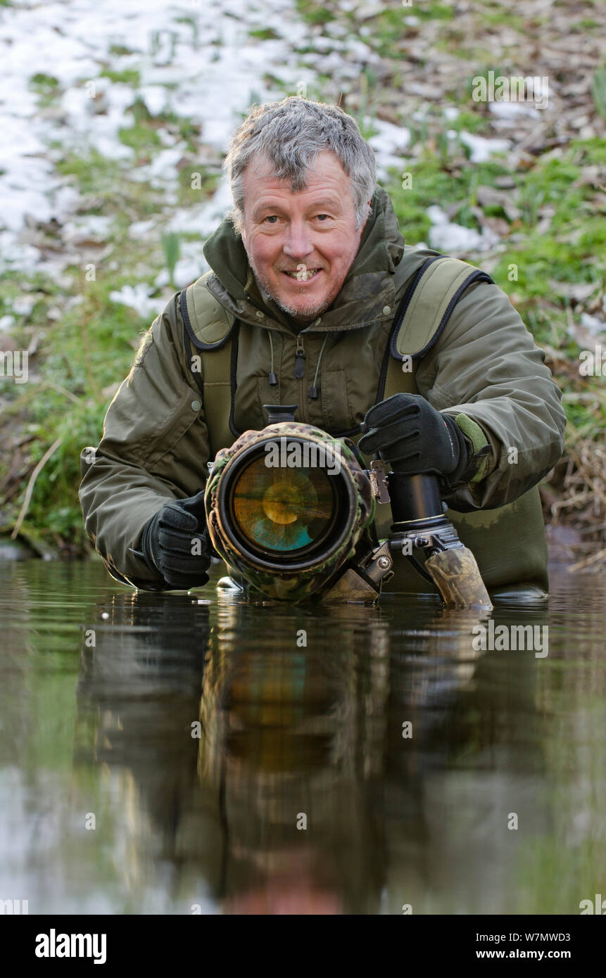 2020VISION Photographer Terry Whittaker photographing water voles (Arvicola terrestris), Kent, England, UK, February 2012. Model released. Stock Photo