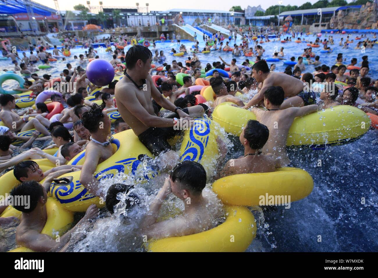 Chinese holidaymakers crowd a swimming pool at a water park in Nanchang