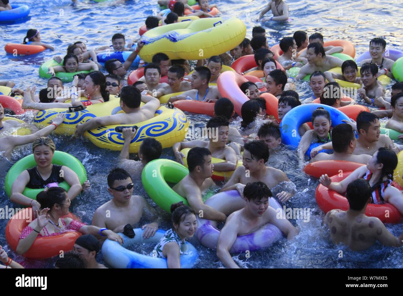 Chinese holidaymakers crowd a swimming pool at a water park in Nanchang