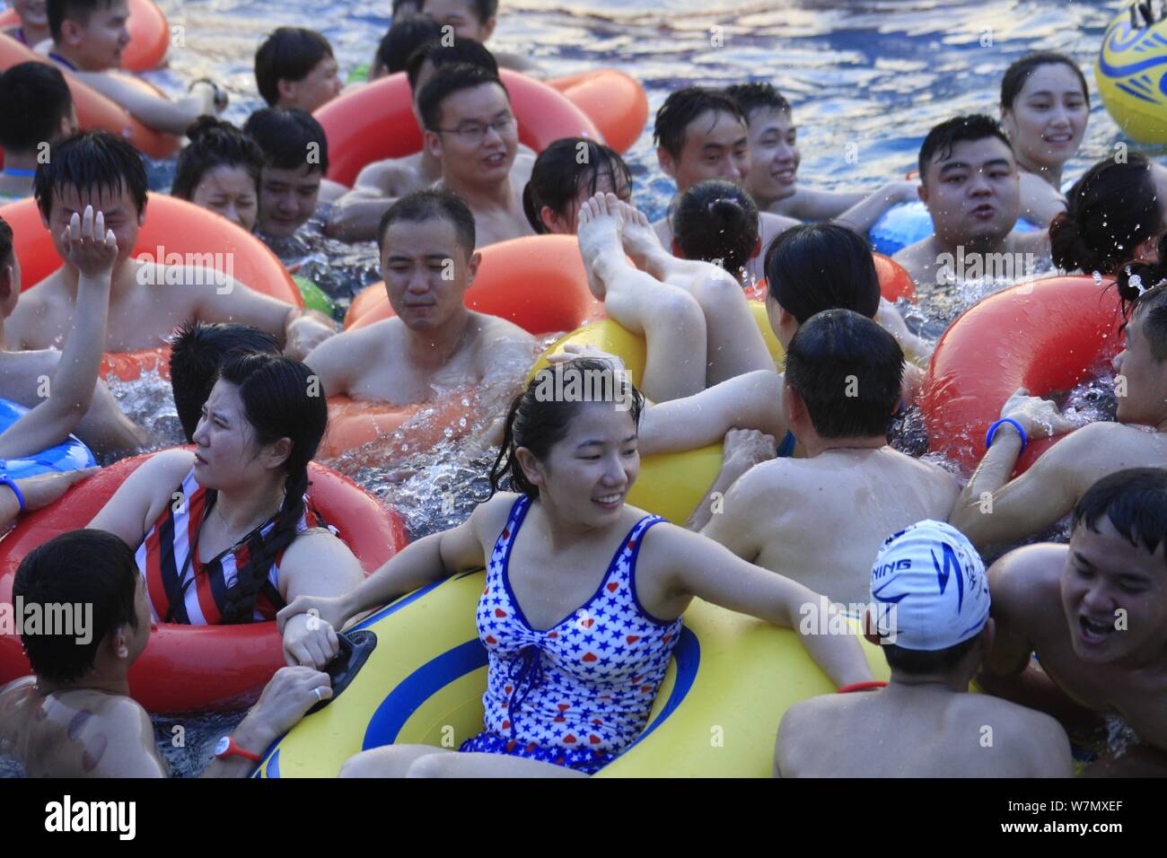 Chinese holidaymakers crowd a swimming pool at a water park in Nanchang