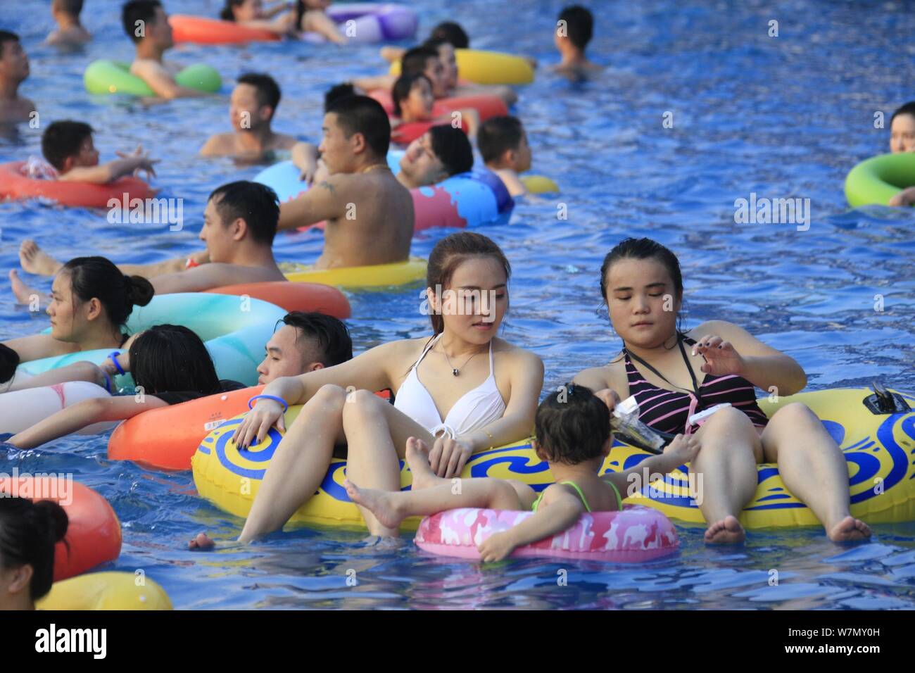 Chinese holidaymakers crowd a swimming pool at a water park in Nanchang