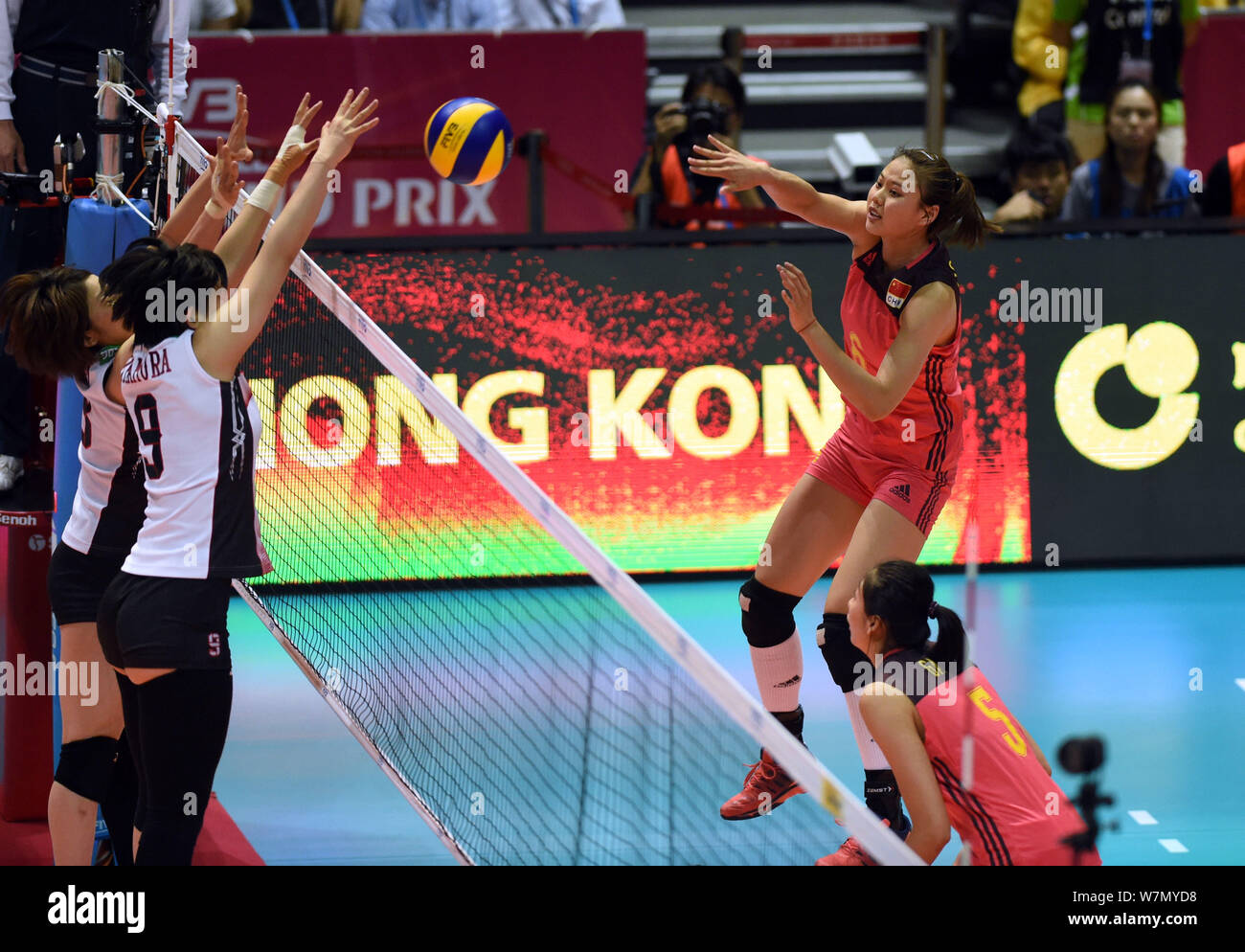 Xiangyu Gong, right, of China spikes against Haruyo Shimamura of Japan during the Pool G1-Group 1 match of the FIVB Volleyball World Grand Prix Hong K Stock Photo