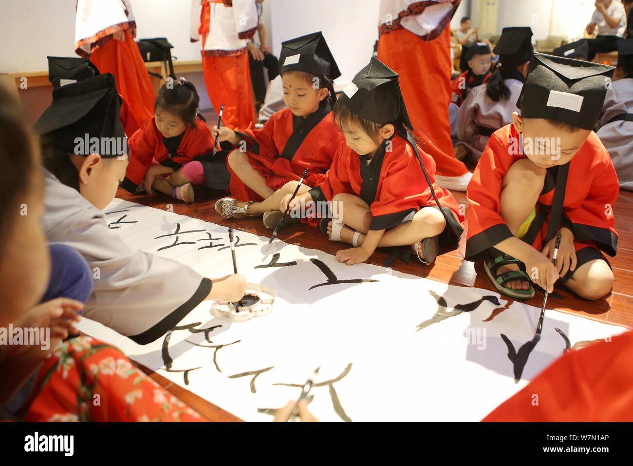 Students write the Chinese character "Ren," meaning "Human" in English