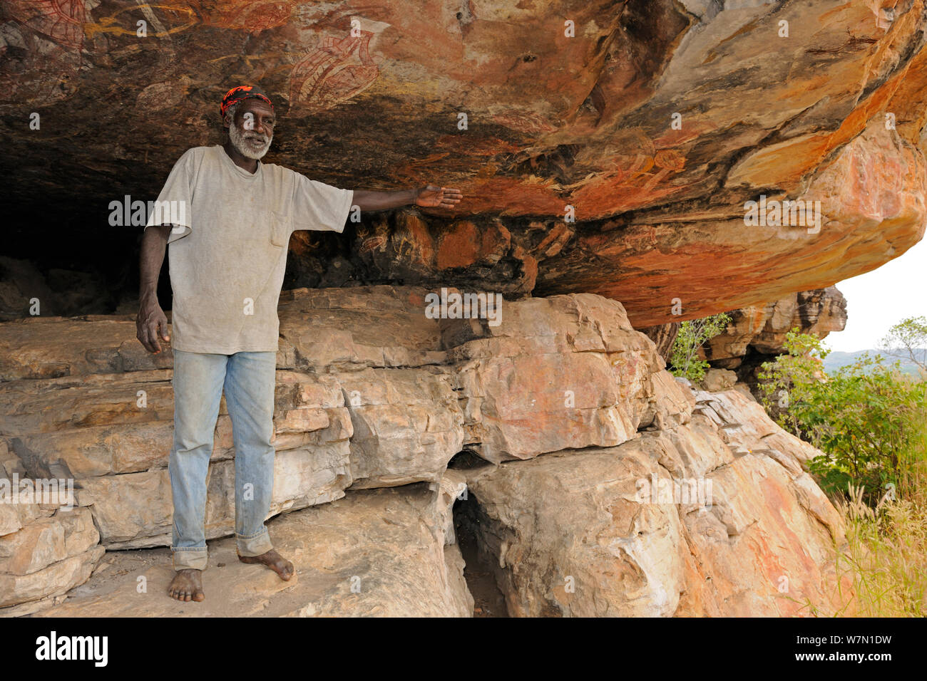 Aboriginal cave art being explained by guide Arnhemland, North West Territories, Australia, May 2009 Stock Photo